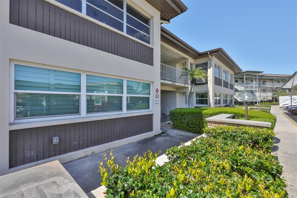 4736 Jasper Drive, Unit 103 New Port Richey, FL 34652 - Photo 4 of 41 a house view with a garden space