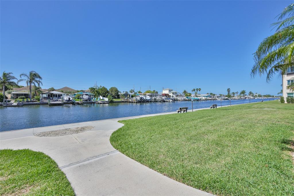 4736 Jasper Drive, Unit 103 New Port Richey, FL 34652 - Photo 6 of 41 a view of a lake with houses in the back