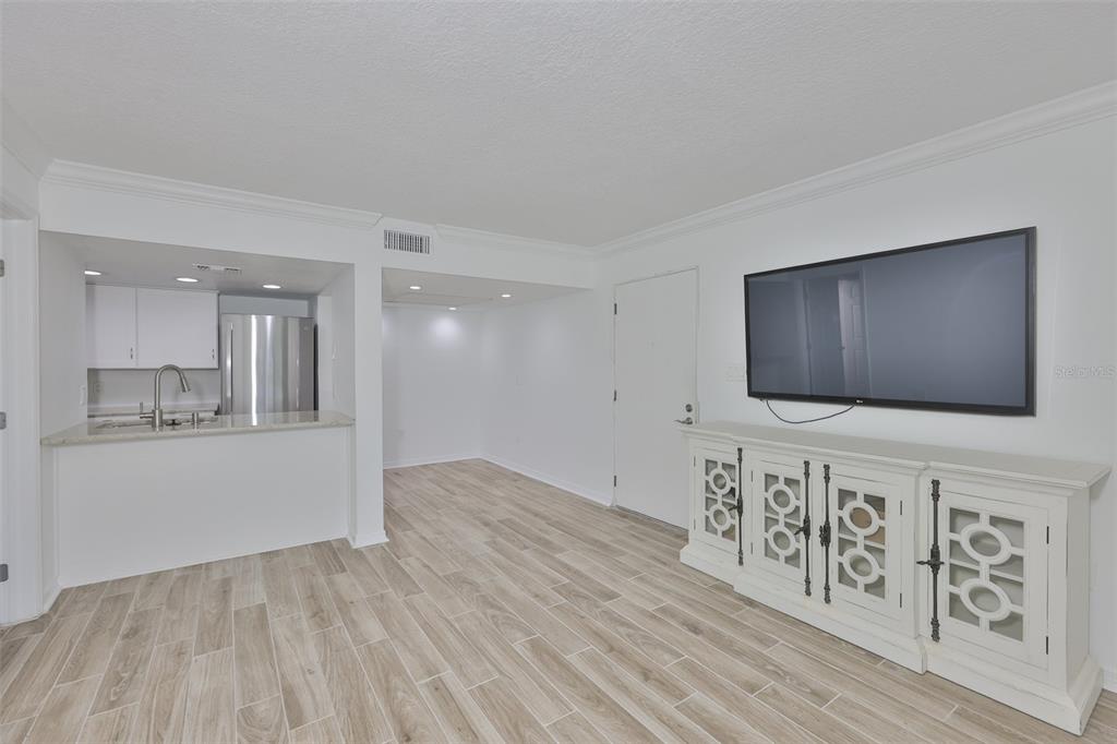 4736 Jasper Drive, Unit 103 New Port Richey, FL 34652 - Photo 9 of 41 a living room with furniture and a flat screen tv