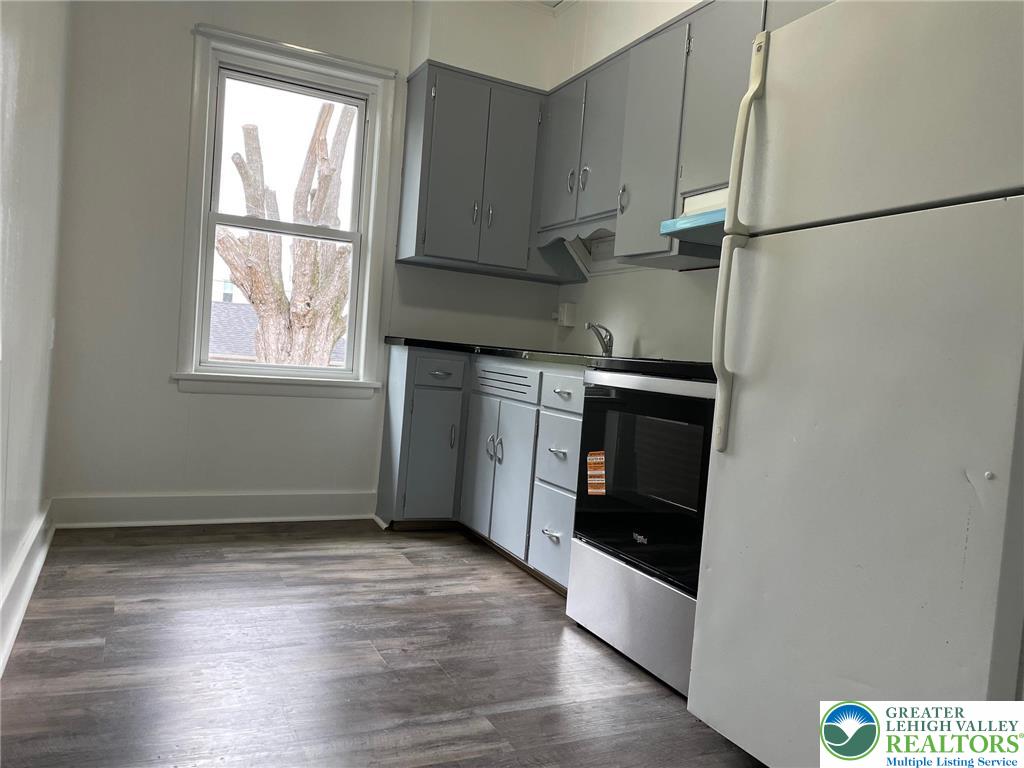 137 South 17th Street Wilson, PA 18042 - Photo 7 of 14 an empty room with wooden floor cabinet and windows