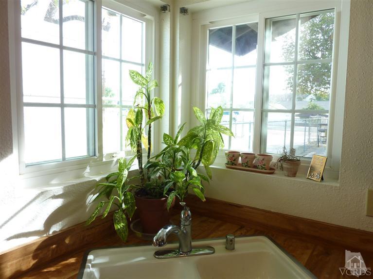 4593 Adam Road Simi Valley, CA 93063 - Photo 6 of 27 a vase of flowers sitting next to a window