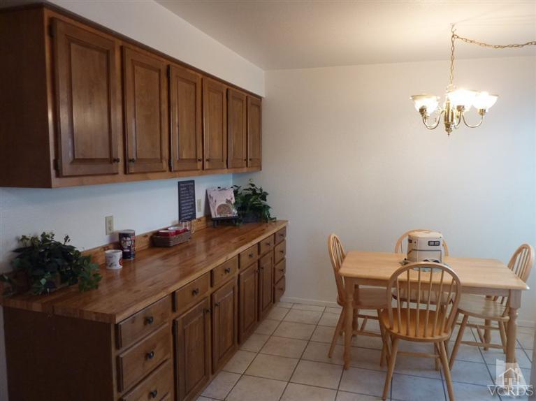 4593 Adam Road Simi Valley, CA 93063 - Photo 8 of 27 a kitchen with a table chairs and cabinets