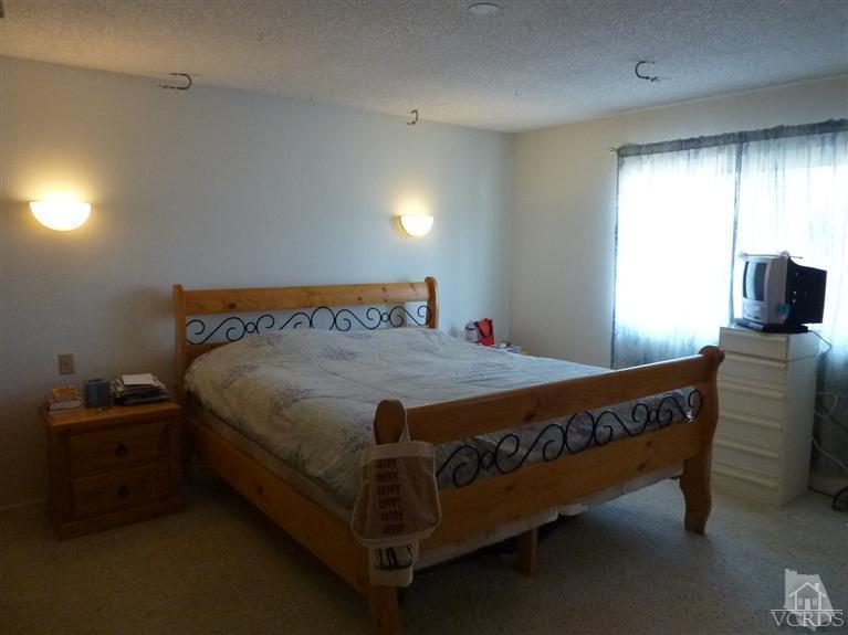 4593 Adam Road Simi Valley, CA 93063 - Photo 10 of 27 a bed sitting in a room next to a window