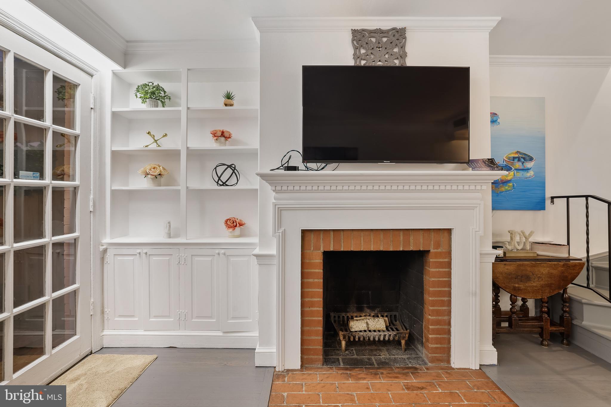 1233 Potomac Street Northwest Washington, DC 20007 - Photo 12 of 26 a living room with a fireplace and a flat screen tv
