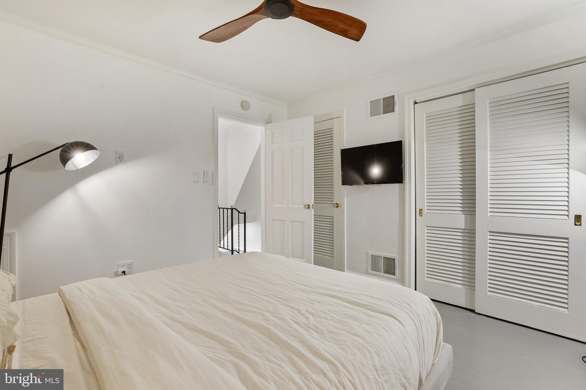 1233 Potomac Street Northwest Washington, DC 20007 - Photo 14 of 26 a bedroom with a bed and a flat screen tv