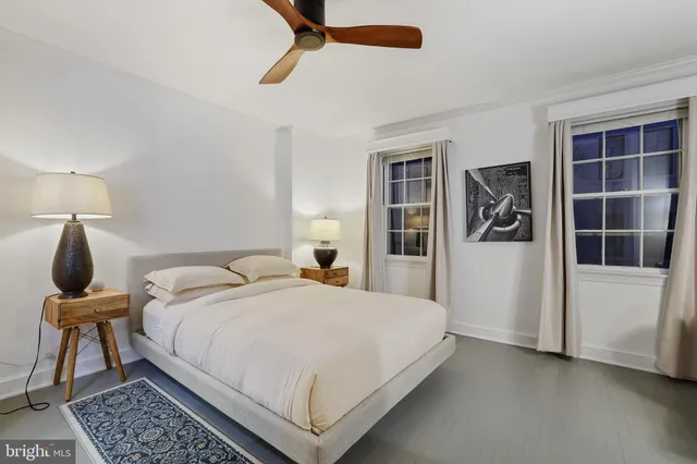 a bedroom with a bed and a table