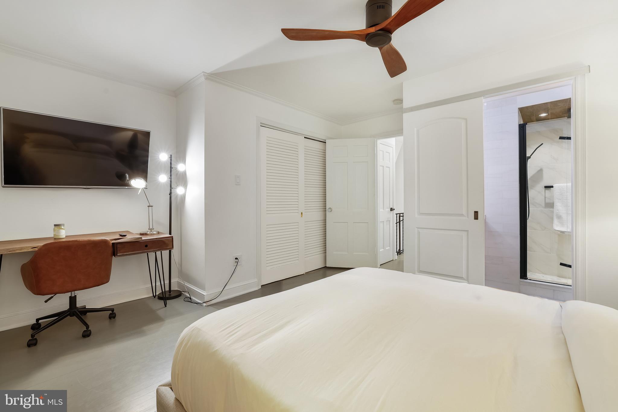 1233 Potomac Street Northwest Washington, DC 20007 - Photo 19 of 26 a bedroom with a bed a flat screen tv and chairs