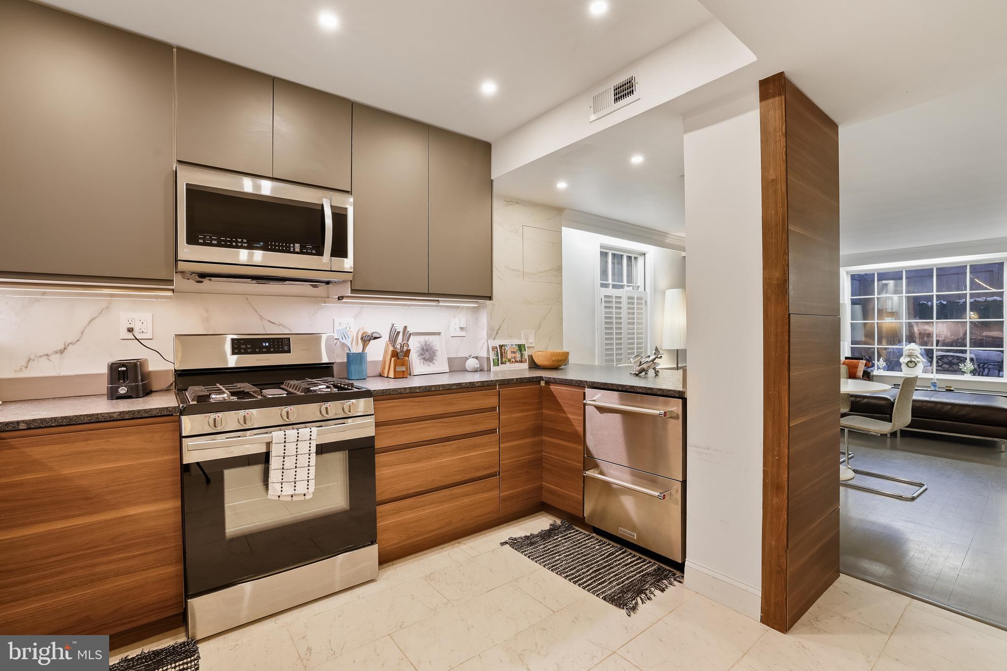 1233 Potomac Street Northwest Washington, DC 20007 - Photo 4 of 26 a kitchen with stainless steel appliances granite countertop a stove and a sink