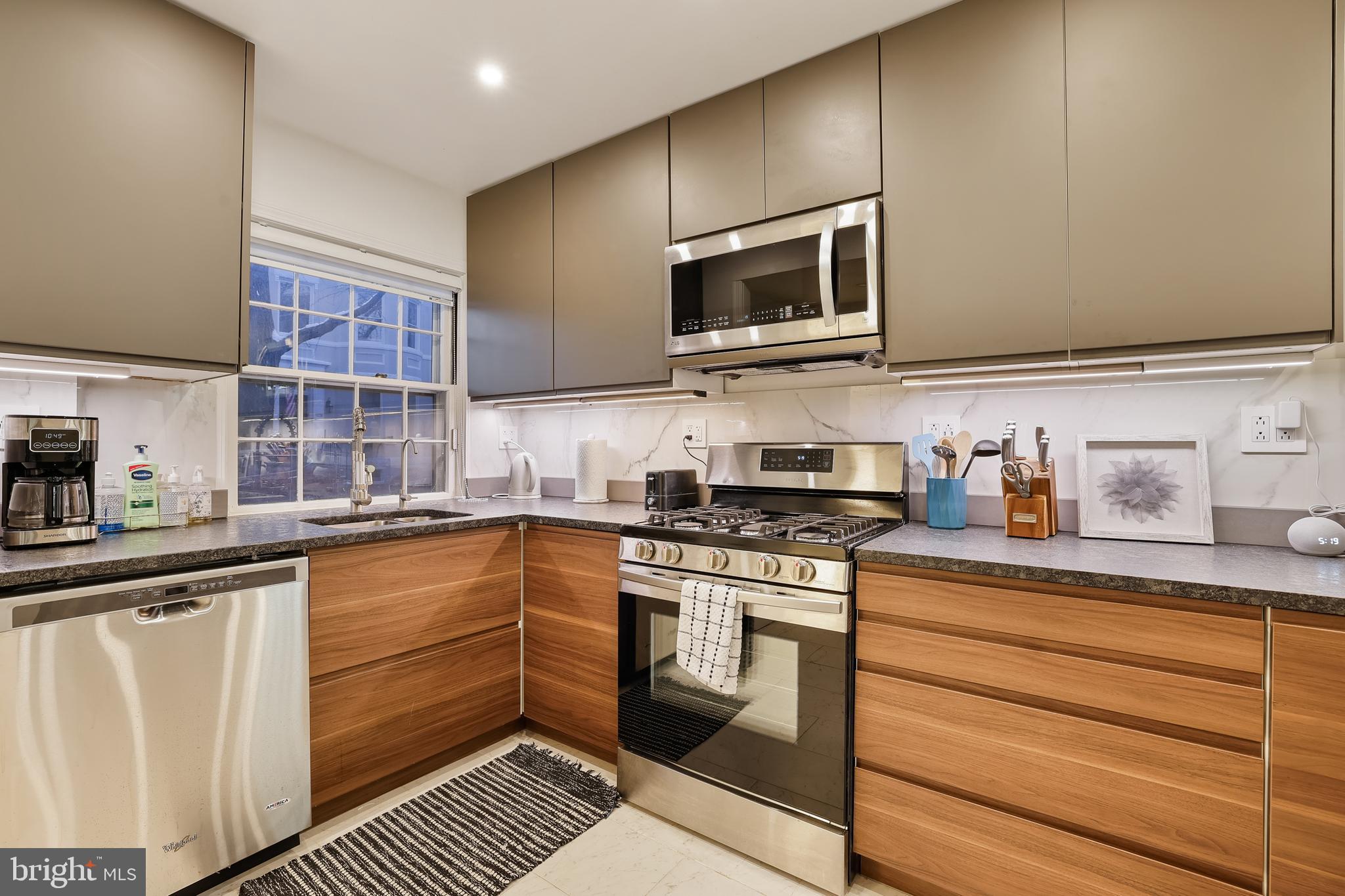1233 Potomac Street Northwest Washington, DC 20007 - Photo 5 of 26 a kitchen with stainless steel appliances granite countertop a sink and a stove