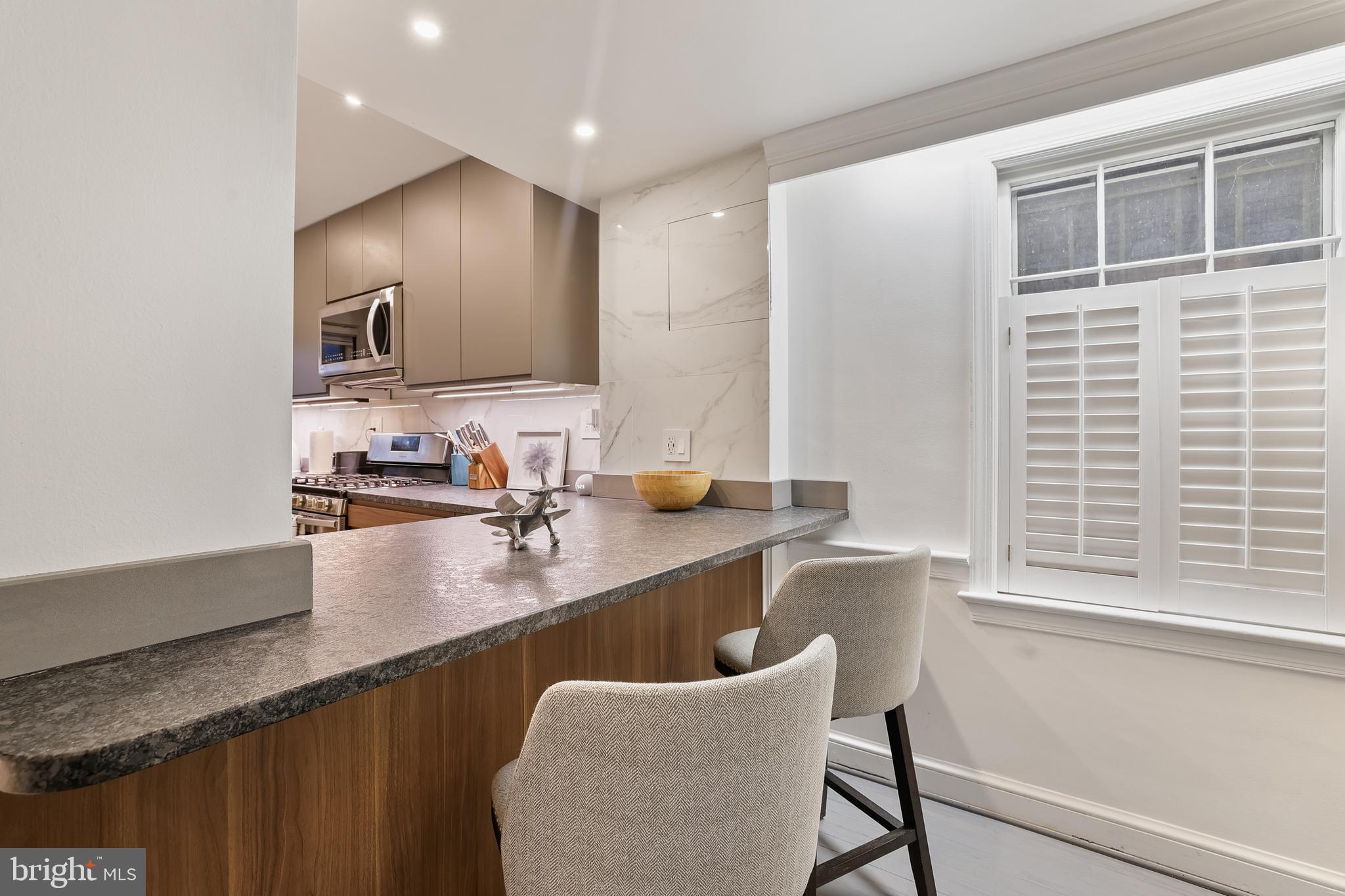 1233 Potomac Street Northwest Washington, DC 20007 - Photo 7 of 26 a kitchen with counter top space cabinets and stainless steel appliances