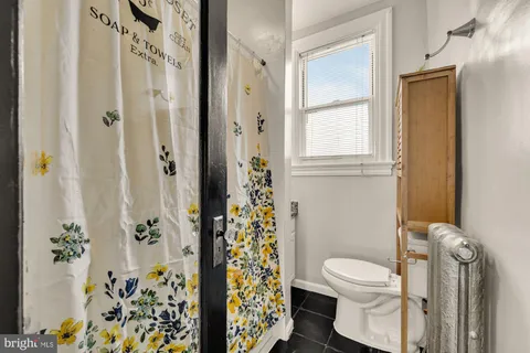 a white toilet sitting next to a bathroom sink