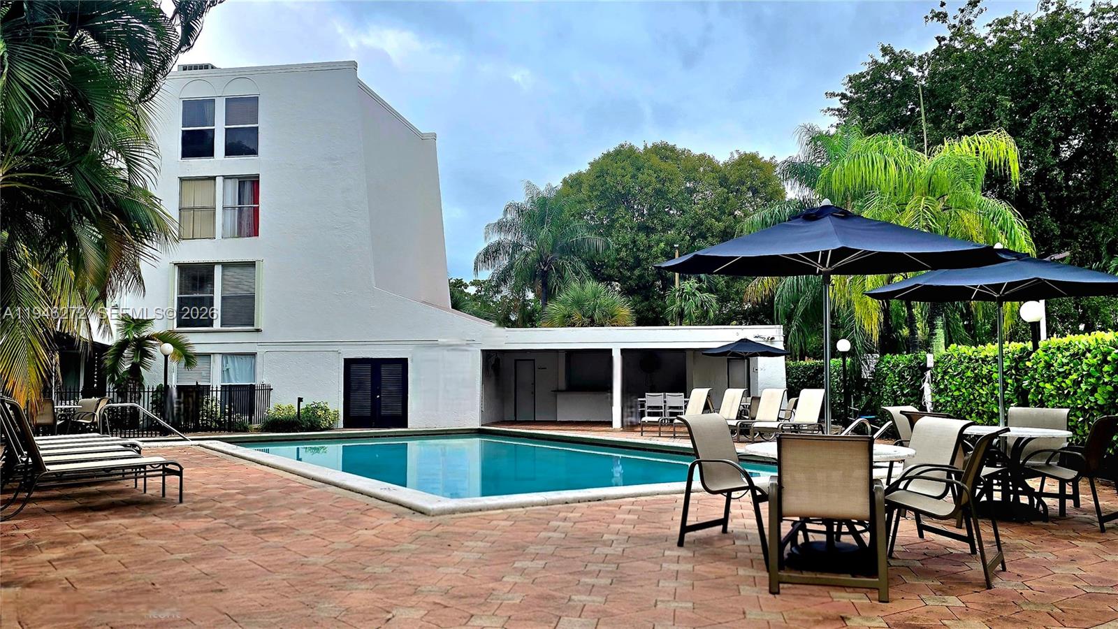 a view of a house with backyard sitting area and garden