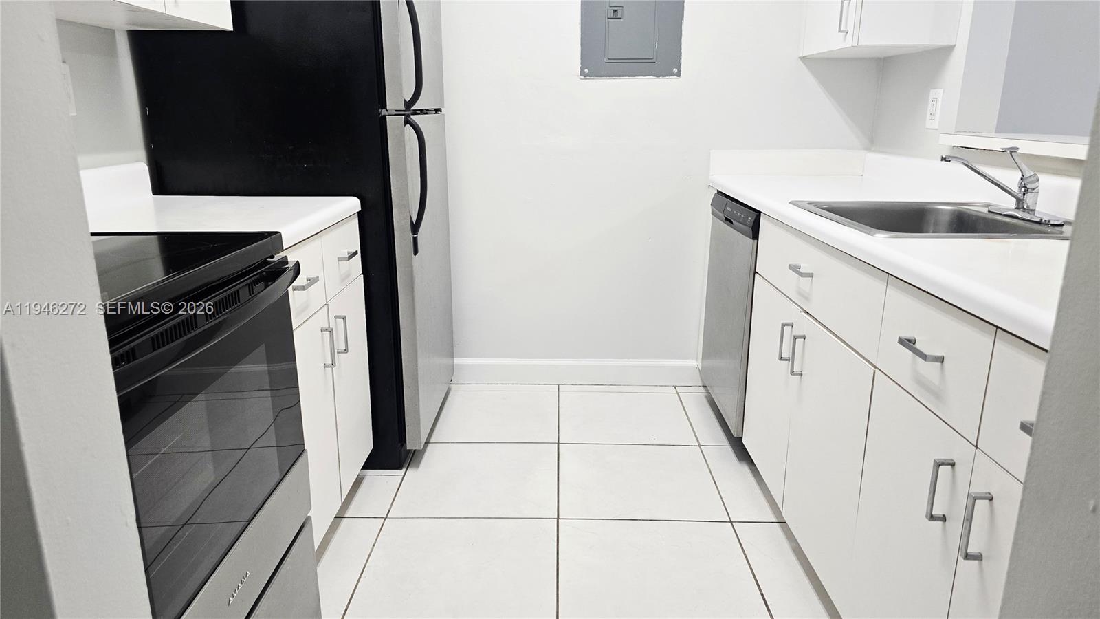 2150 Southwest 16th Avenue, Unit 206 Miami, FL 33145 - Photo 16 of 40 a kitchen with a sink and washing machine