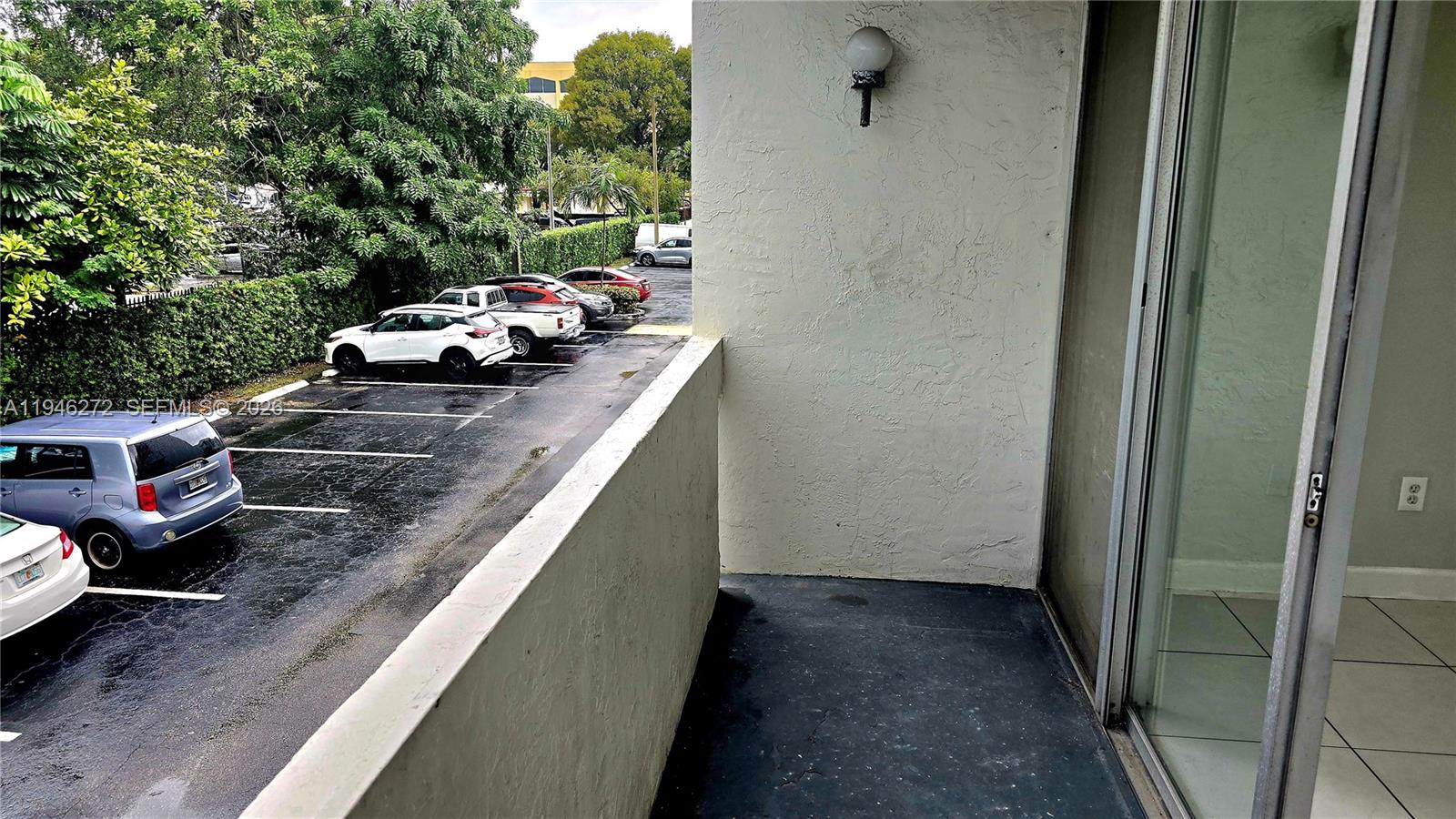 2150 Southwest 16th Avenue, Unit 206 Miami, FL 33145 - Photo 19 of 40 a view of a balcony with cars parked