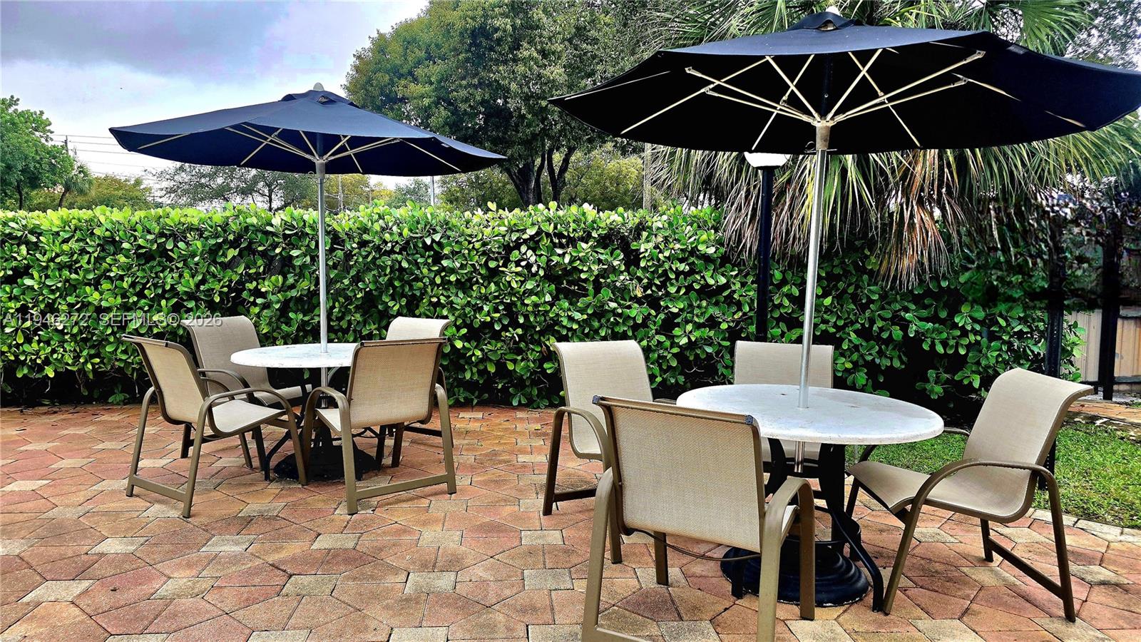 2150 Southwest 16th Avenue, Unit 206 Miami, FL 33145 - Photo 27 of 40 a patio table and chairs under an umbrella