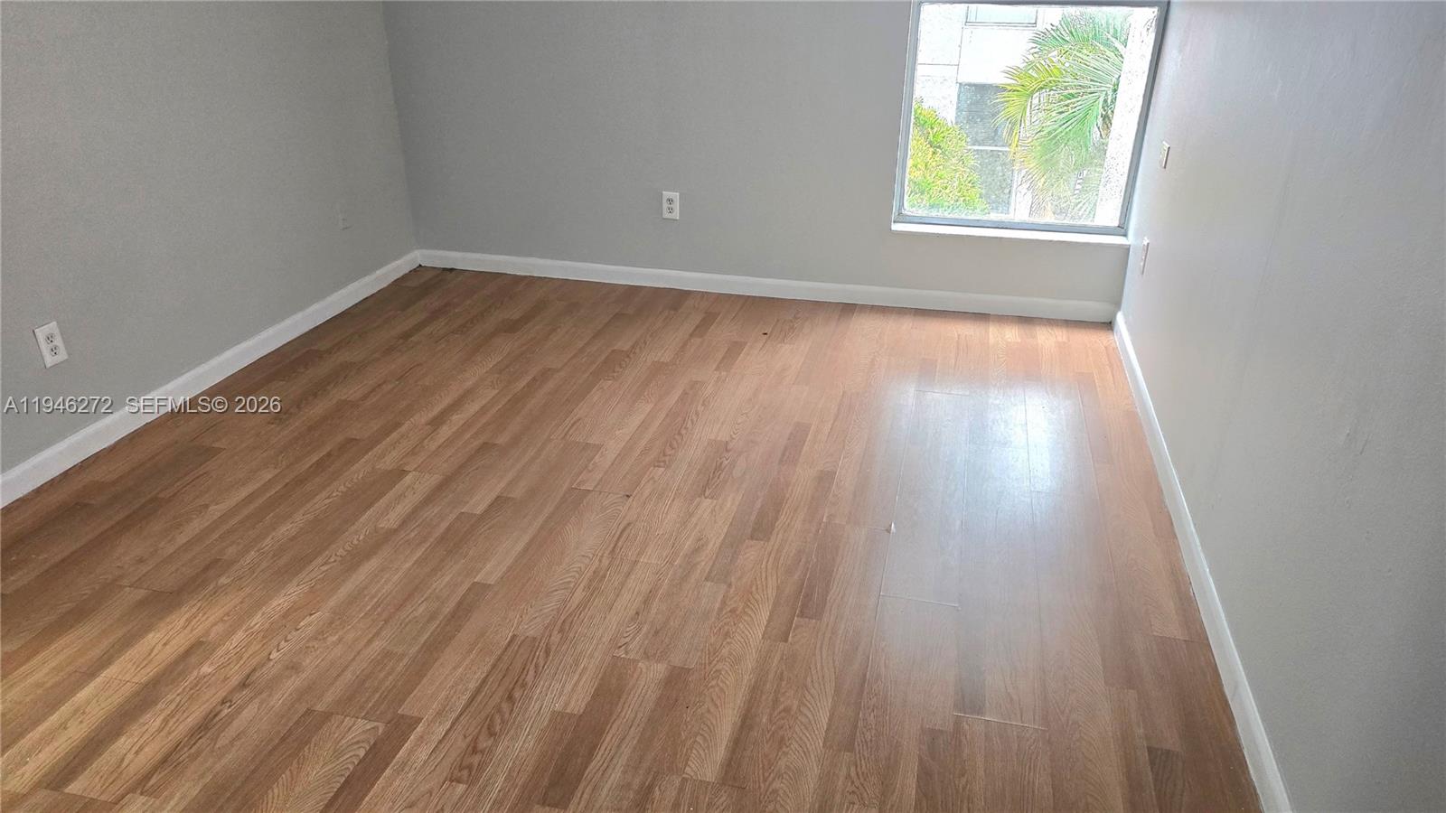 2150 Southwest 16th Avenue, Unit 206 Miami, FL 33145 - Photo 5 of 40 wooden floor in an empty room with a window
