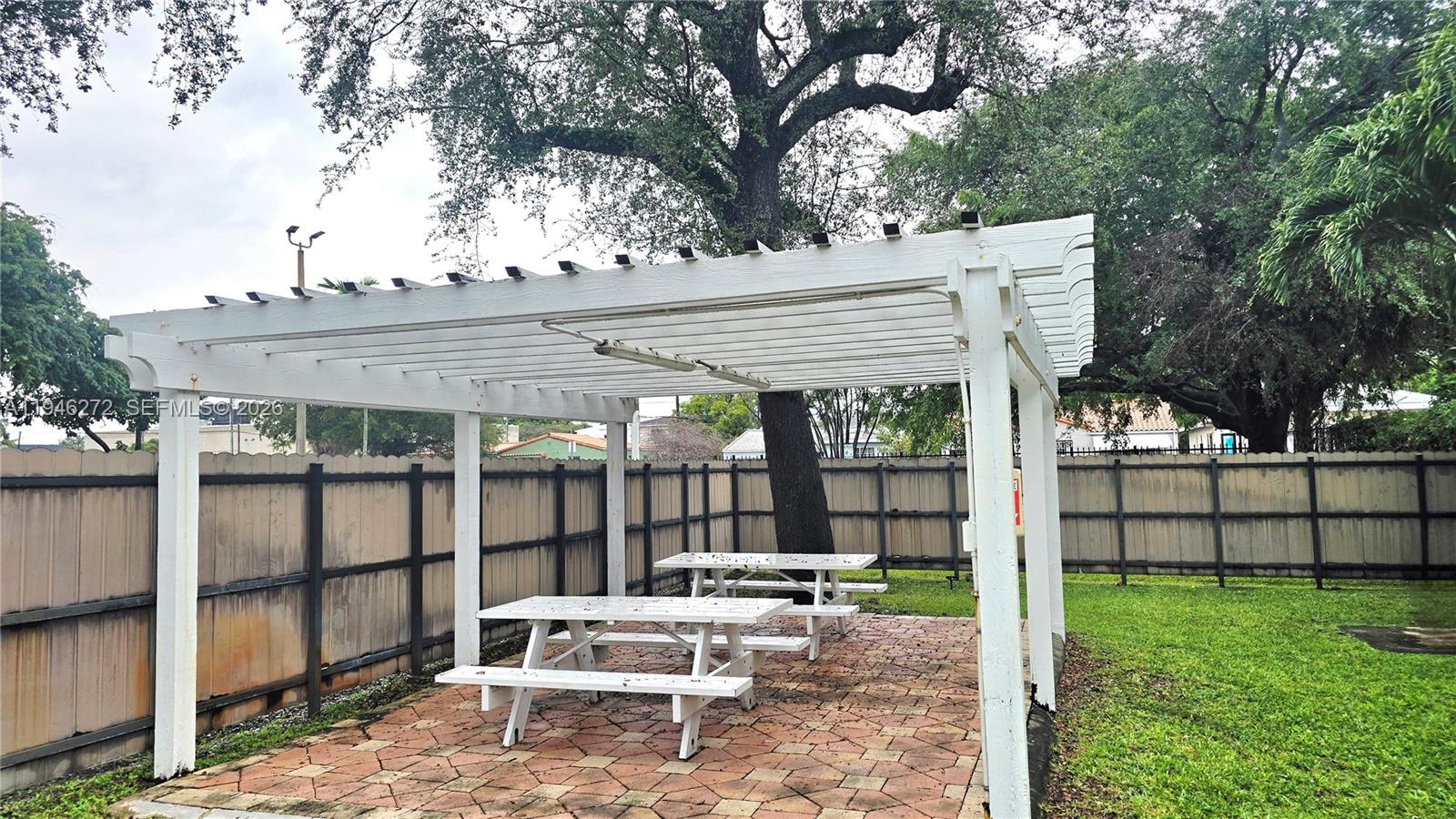 2150 Southwest 16th Avenue, Unit 206 Miami, FL 33145 - Photo 9 of 40 a view of a patio with a table and chairs under an umbrella