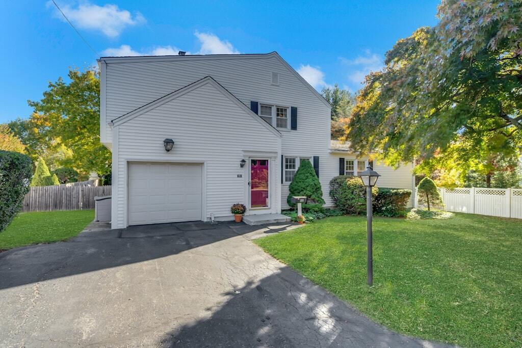 a front view of house with yard and green space