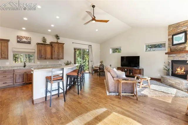 a living room with furniture a flat screen tv and kitchen view
