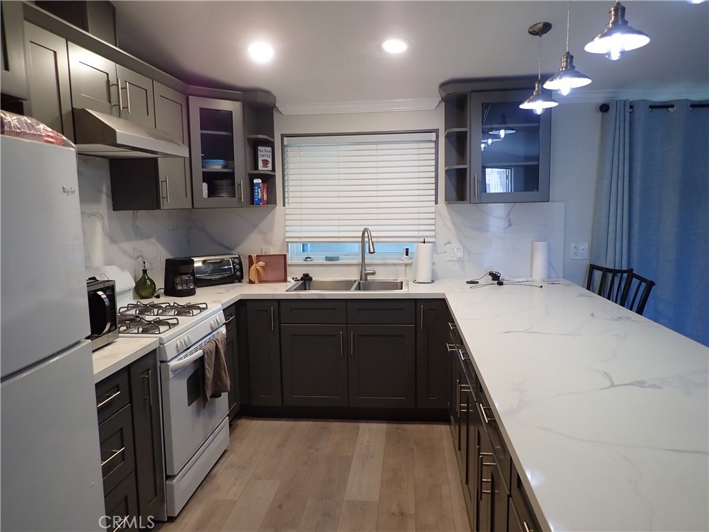 27250 Murrieta Road, Unit 386 Menifee, CA 92586 - Photo 10 of 32 a kitchen with stainless steel appliances granite countertop a sink a stove and a refrigerator
