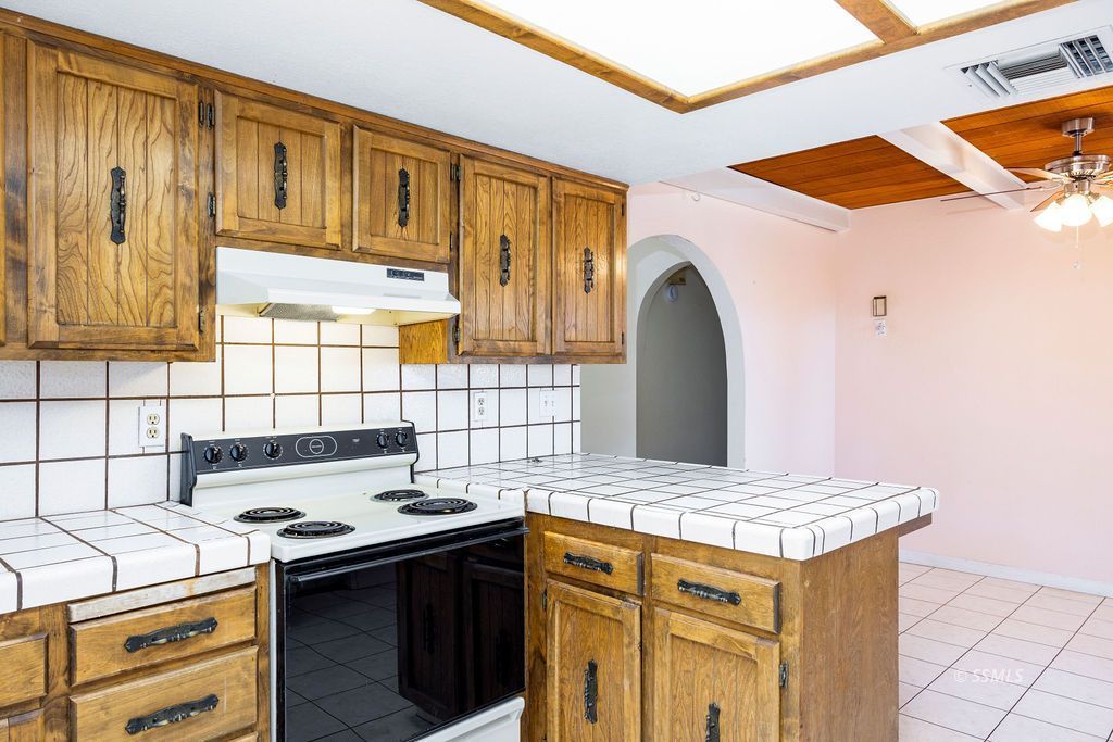 1144 West Benson Avenue Ridgecrest, CA 93555 - Photo 13 of 32 a kitchen with a stove and a sink