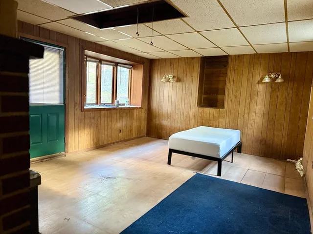 a living room with furniture gym equipment and a window