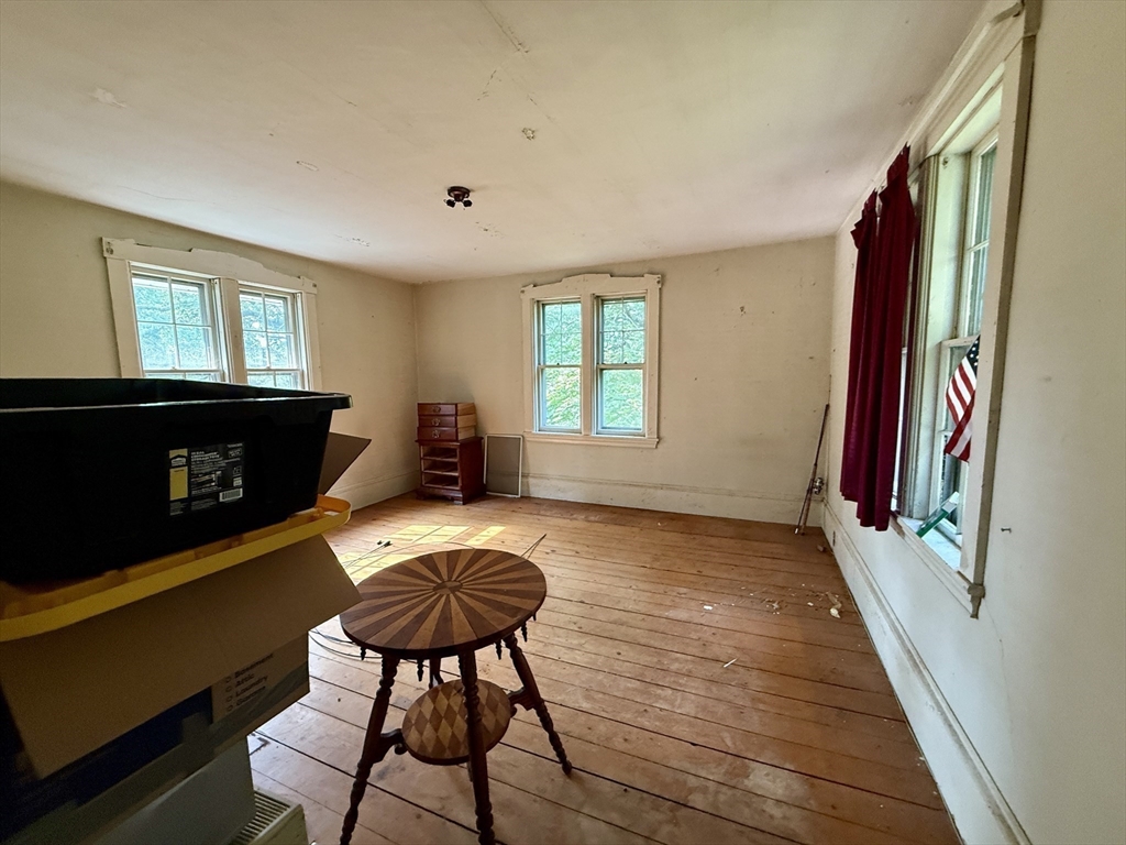 11 Danforth Park Road Framingham, MA 01701 - Photo 23 of 33 a view of a livingroom with furniture a fireplace and windows