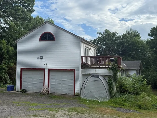 a view of a house with backyard and sitting area