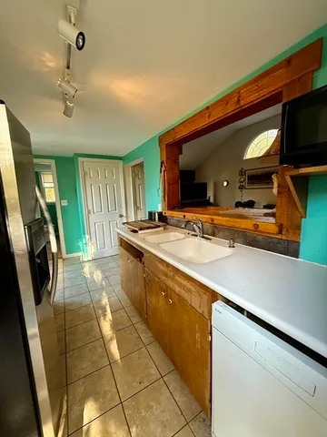 a spacious bathroom with a sink a large mirror and a shower