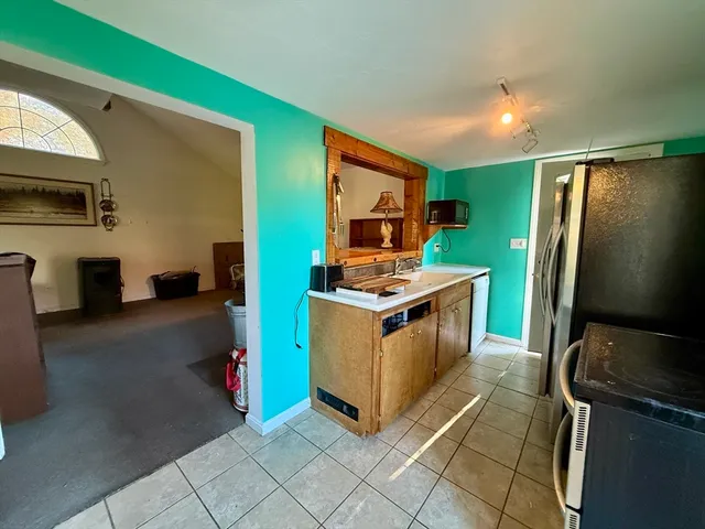 a kitchen with stainless steel appliances a stove refrigerator and microwave