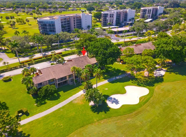 a view of a swimming pool with a yard and plants