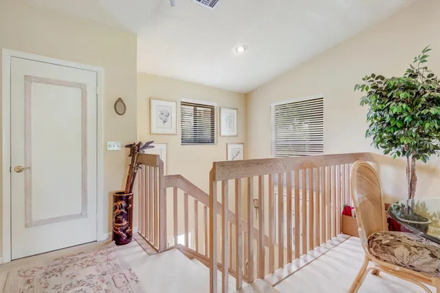 a bedroom with furniture a window and a potted plant
