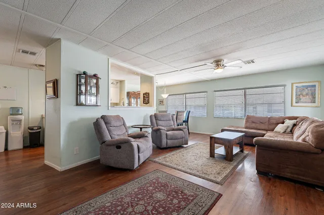 a living room with furniture and wooden floor