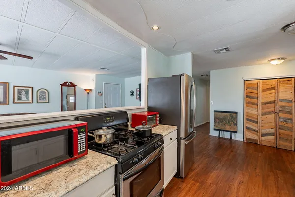 a kitchen with stainless steel appliances granite countertop a stove and a refrigerator