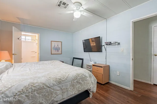 a bedroom with a bed and a flat screen tv