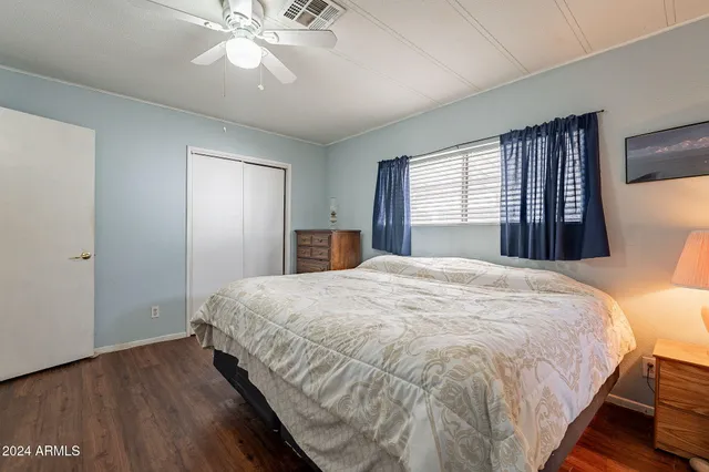 a spacious bedroom with a bed and a chandelier