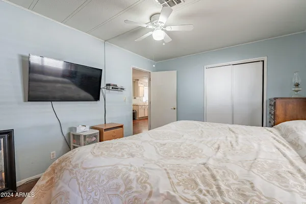 a bedroom with a bed and a flat screen tv