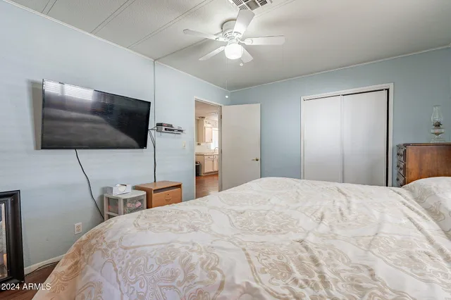 a bedroom with a bed and a flat screen tv