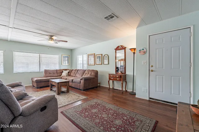 a living room with furniture rug and window