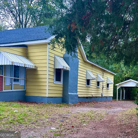 a front view of a house with garden