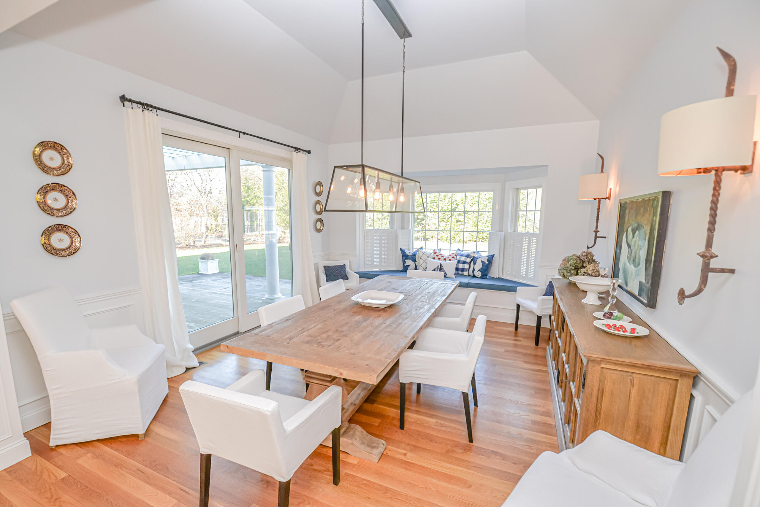 53 Rd To The Plaines Edgartown, MA 02539 - Photo 7 of 35 a view of a dining room with furniture a chandelier and wooden floor