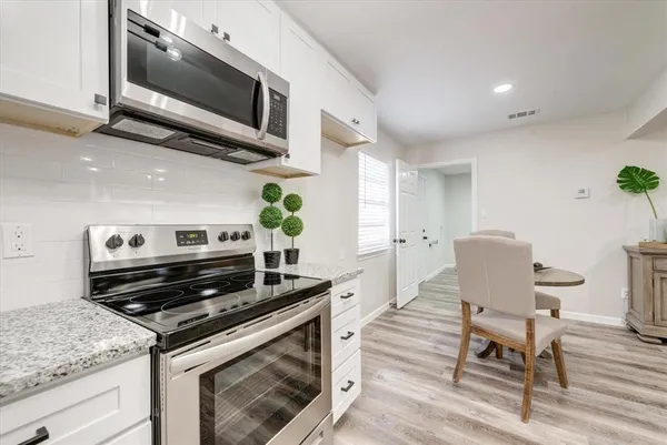 a kitchen with a stove and a microwave