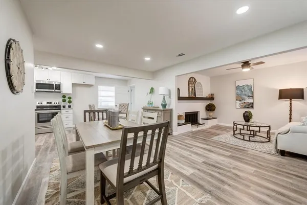 a view of a dining room with furniture and wooden floor