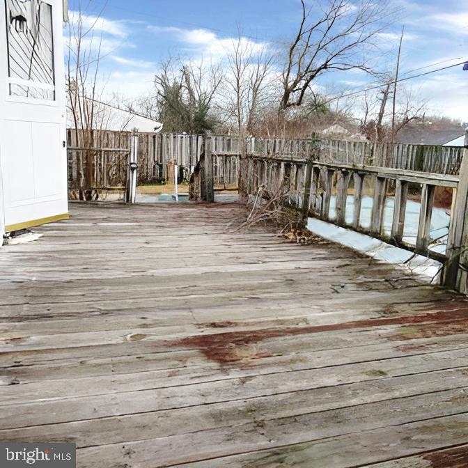 718 Mayo Road Glen Burnie, MD 21061 - Photo 35 of 48 Weathered deck with a serene backdrop.