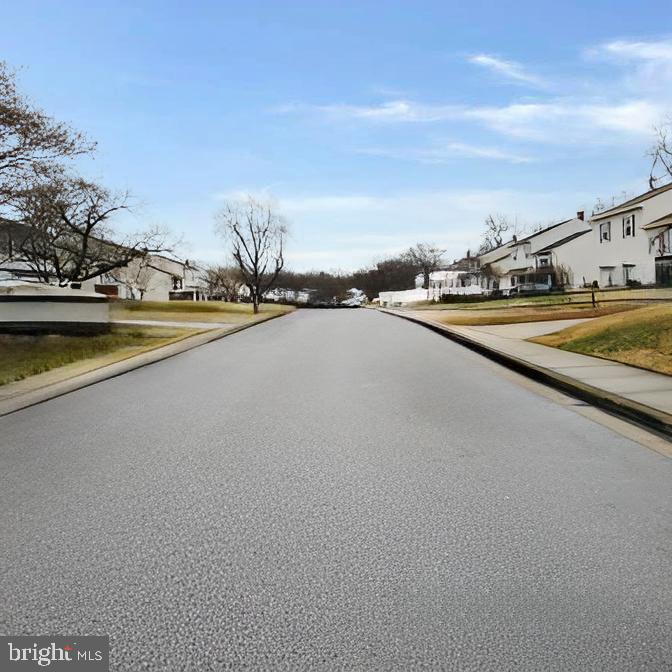 718 Mayo Road Glen Burnie, MD 21061 - Photo 47 of 48 Tranquil suburban street under a clear sky.