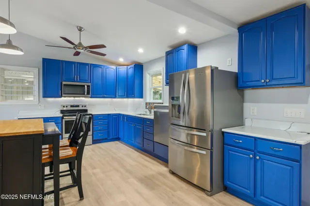 a kitchen with wooden cabinets and stainless steel appliances