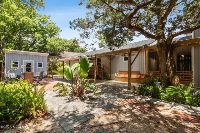 front view of a house with a large tree