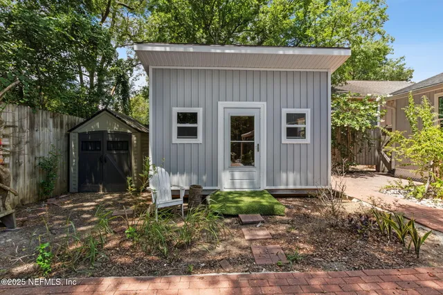 a backyard of a house with yard and outdoor seating