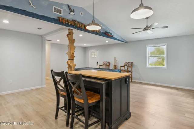 a dining room with a wooden table and chairs