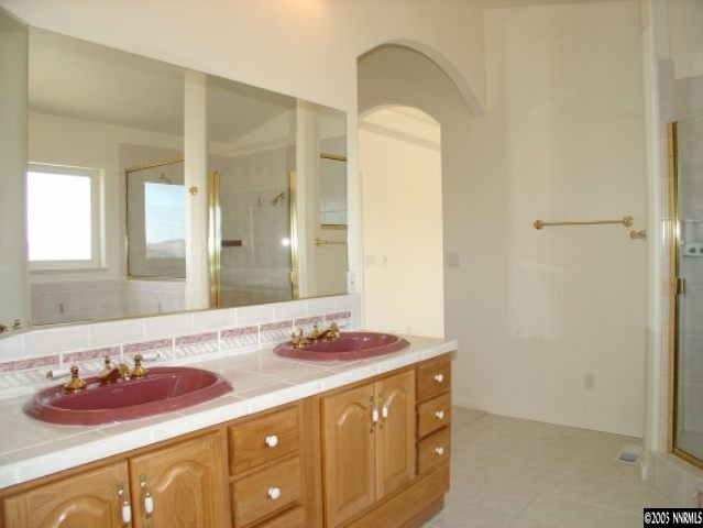 3100 Coronado Way Reno, NV 89503 - Photo 6 of 9 a bathroom with a granite countertop sink and a mirror